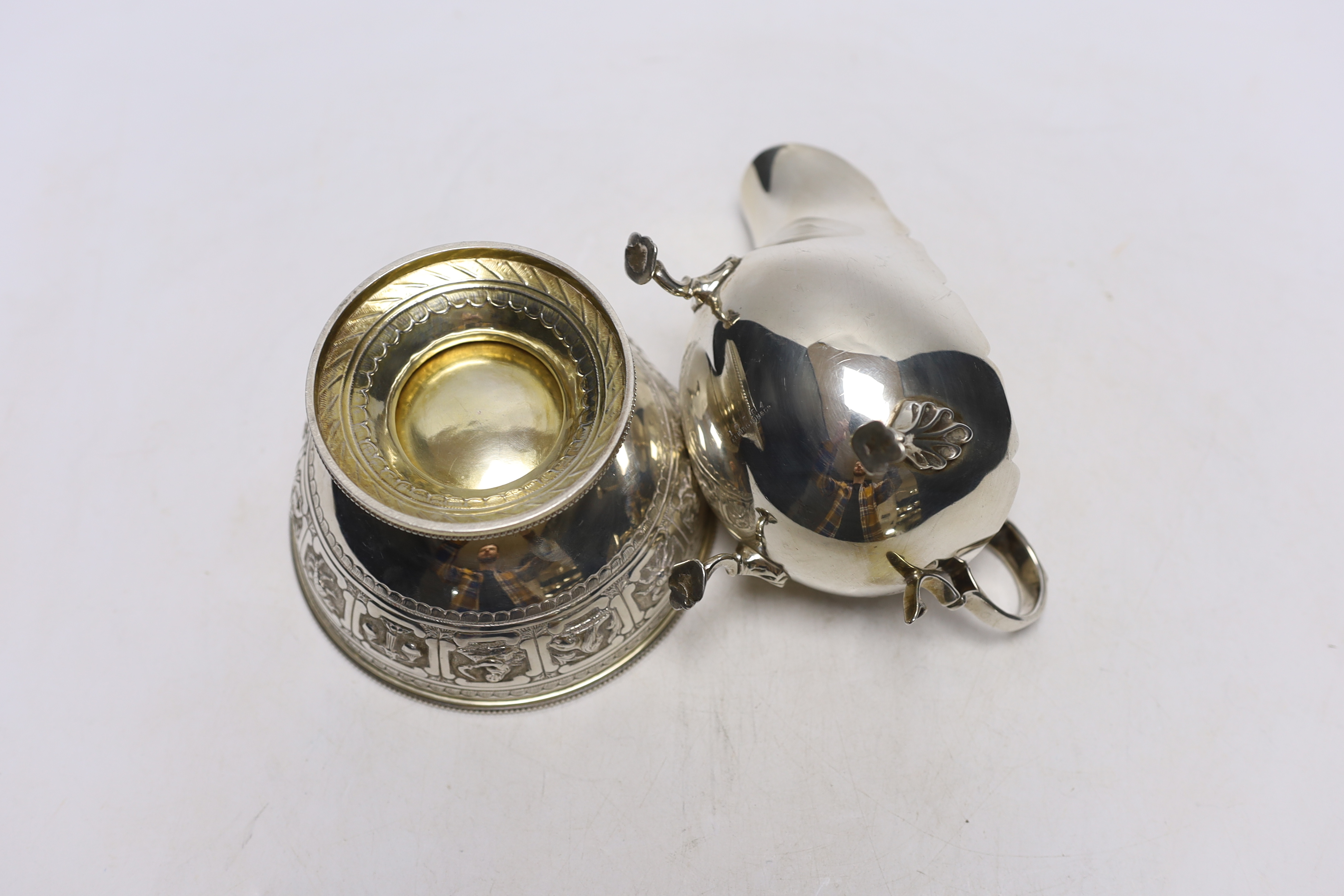 A Victorian silver 'Zodiac' pedestal bowl, by Frederick Elkington. London, 1881, diameter 12.4cm and a later silver sauceboat, 14.1oz.